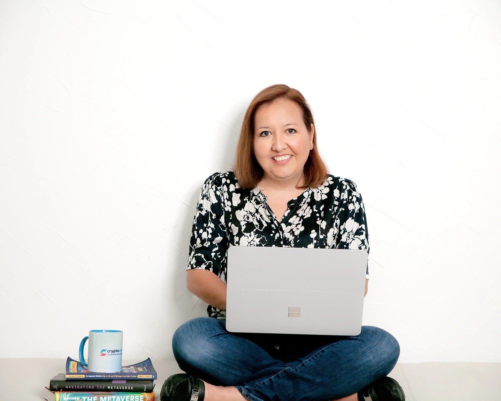 Monica Talan seated with a laptop in a workspace